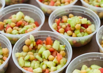 tomatoes and cucumbers in plastic containers.