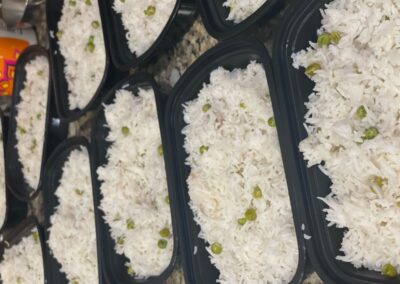 rice and peas in plastic containers on a counter for the Dine for a Cause