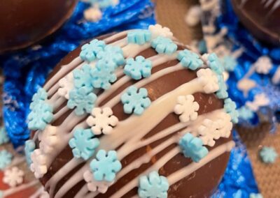 snowflake truffles covered in blue and white icing from our arts and crafts market