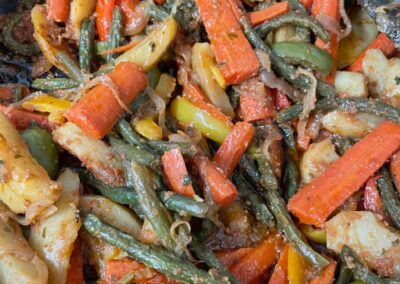 A frying pan with vegetables in it during our Ethiopian Flavors class