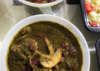 Two containers with delicious food on a table.