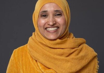 Chef Semira Abdu in a yellow hijab and sweater smiling
