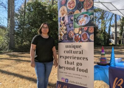 Babita standing in front of our tent at the Shakerag Arts and Crafts Market