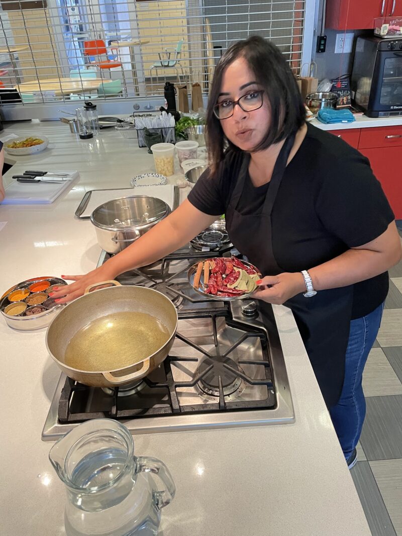 Preparing food in a kitchen during the Classic North Indian Cooking with BeBe.