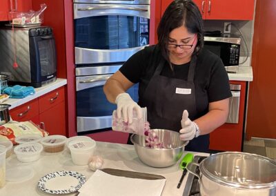 Chef BeBe preparing food in a kitchen during a Classic North Indian Cooking Class