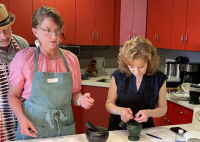 A group of people in a kitchen cooking in a Classic North Indian Cooking Class with BeBe.