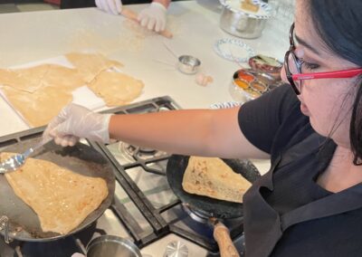 A group of people preparing North Indian food in a cooking class near Atlanta