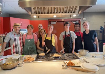 A group of people posing for a photo during the Classic North Indian Cooking with BeBe