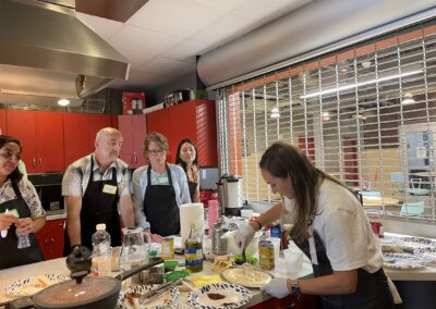 A group of people participating in the Lebanese Cooking Class with Jihan in a kitchen.