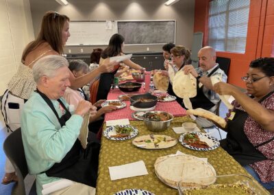 A group of people sitting around a table taking the Lebanese Cooking Class with Jihan.