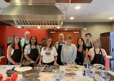 A group of people taking a Lebanese Cooking Class with Jihan in a kitchen.