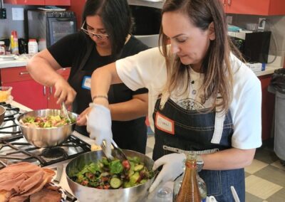 Two women participating in the Lebanese Cooking Class with Jihan in a kitchen.