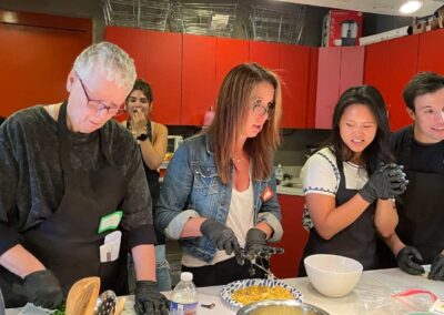 A group of people preparing food in a Venezuelan Cuisine Cooking Class with Ximena