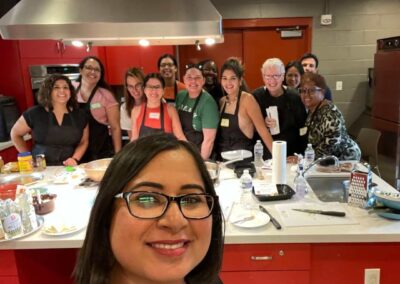 A group of people posing for a photo in a Venezuelan Cuisine cooking class