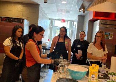 A group of people preparing food in a Venezuelan Cuisine cooking class