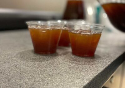 Three cups of drinks sitting on a counter.during the Venezuelan Cuisine with Ximena Cooking Class