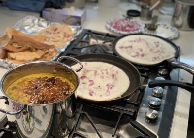 Pots of South Indian Cuisine with BeBe on a stove.
