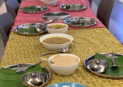 A long table with plates and bowls of South Indian Cuisine from the Cooking Class with Bebe